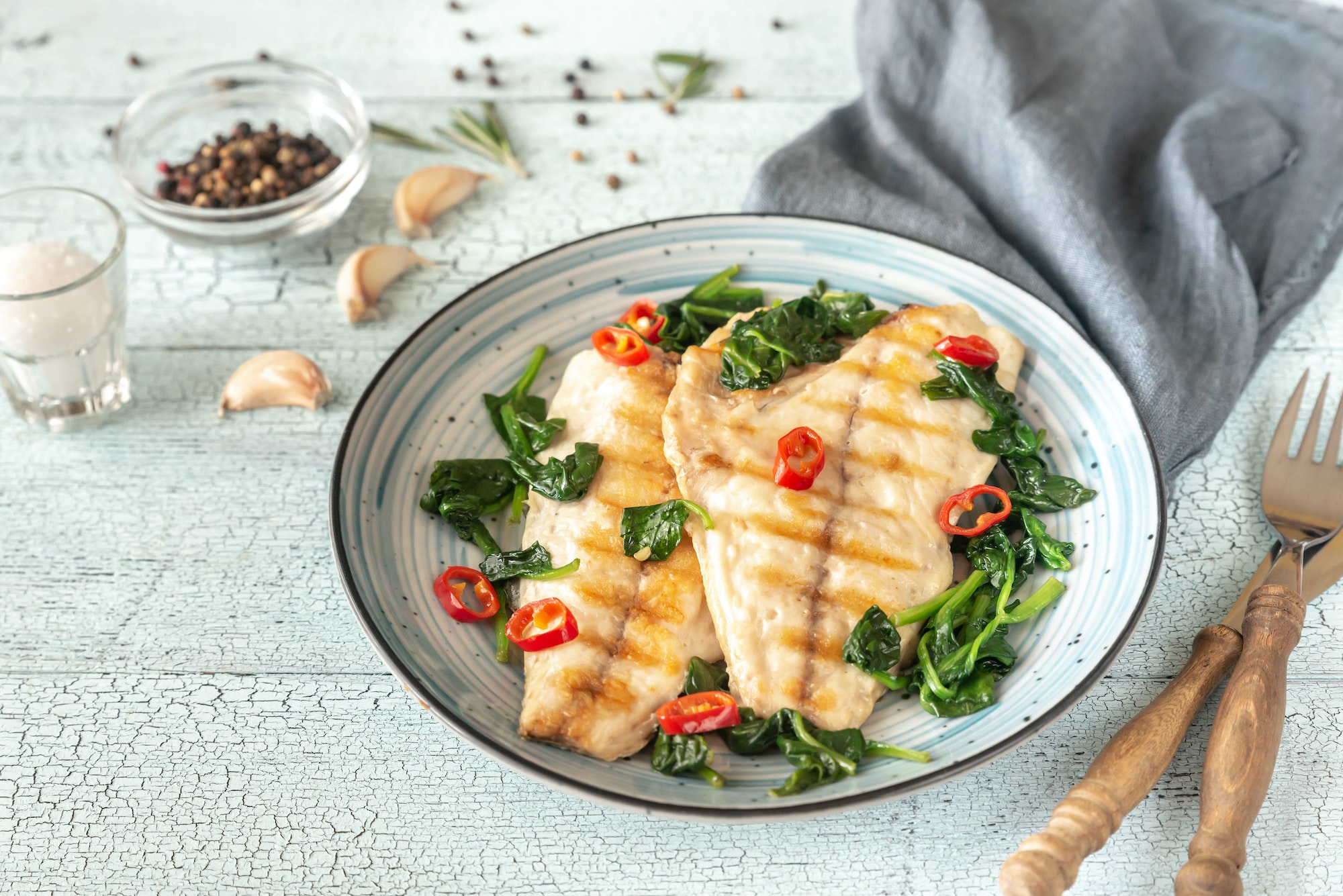 Grilled sea bream fish fillet with spinach